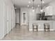 Open-concept kitchen with granite countertops, stainless steel appliances, and breakfast bar seating at 31355 Amberview Bnd, Wesley Chapel, FL 33545