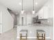 Kitchen with stainless appliances, granite counters and two pendant lights overhanging the breakfast bar at 31355 Amberview Bnd, Wesley Chapel, FL 33545