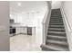Bright kitchen with stainless steel appliances, kitchen island, and adjacent staircase at 31355 Amberview Bnd, Wesley Chapel, FL 33545