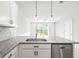 Kitchen featuring granite countertops, stainless steel appliances, and view of back yard at 31355 Amberview Bnd, Wesley Chapel, FL 33545