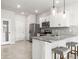 Bright kitchen featuring white cabinets, stainless steel appliances, granite counters, and pendant lighting at 31355 Amberview Bnd, Wesley Chapel, FL 33545