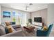 Inviting living room with large window, neutral color palette, and modern furnishings at 31355 Amberview Bnd, Wesley Chapel, FL 33545