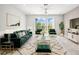 Stylish living room showcasing plush velvet seating and sun-filled sliding glass doors at 31355 Amberview Bnd, Wesley Chapel, FL 33545