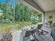 Secluded backyard patio has lovely tropical foliage and an area for outdoor dining at 3138 Nautical S Pl, St Petersburg, FL 33712