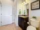 Cozy bathroom features granite countertops, a dark wood vanity, and a decorative framed art piece at 3138 Nautical S Pl, St Petersburg, FL 33712