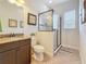 This bathroom offers a glass enclosed shower, granite countertop vanity, and neutral tones for a relaxing experience at 3138 Nautical S Pl, St Petersburg, FL 33712