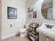 Charming bathroom with a pedestal sink, decorative artwork, and a unique nautical theme at 3138 Nautical S Pl, St Petersburg, FL 33712