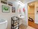 This is a bathroom with an oval mirror, pedestal sink and decorative artwork on the wall at 3138 Nautical S Pl, St Petersburg, FL 33712