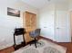 Bedroom featuring hardwood floors, a ceiling fan and a built-in desk with a printer and decorative rug at 3138 Nautical S Pl, St Petersburg, FL 33712