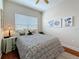 Comfortable bedroom featuring a ceiling fan, decorative bedding, side table, and natural light from the window at 3138 Nautical S Pl, St Petersburg, FL 33712