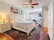 This bedroom has an area rug, ceiling fan, and a large bed with a window at 3138 Nautical S Pl, St Petersburg, FL 33712