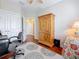 Bedroom features hardwood floors, a ceiling fan, and a decorative rug. Also a built-in dresser and open closet at 3138 Nautical S Pl, St Petersburg, FL 33712