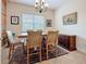Formal dining room with wooden table, six chairs, and sideboard at 3138 Nautical S Pl, St Petersburg, FL 33712