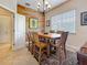 This dining room features a colorful accent wall and a rustic wood table with seating for six, and natural light at 3138 Nautical S Pl, St Petersburg, FL 33712