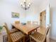 Cozy dining room featuring a wood table, decorative chandelier, and access to other areas of the home at 3138 Nautical S Pl, St Petersburg, FL 33712