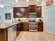 Well-equipped kitchen featuring stainless steel appliances, dark cabinetry, and granite countertops at 3138 Nautical S Pl, St Petersburg, FL 33712