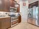 Well-equipped kitchen with stainless steel appliances, granite countertops, and dark wood cabinets at 3138 Nautical S Pl, St Petersburg, FL 33712
