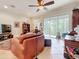 Comfortable living room with a large leather couch, tile floors, and screened lanai access at 3138 Nautical S Pl, St Petersburg, FL 33712