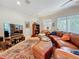 Cozy living room with leather furniture, TV, and large windows at 3138 Nautical S Pl, St Petersburg, FL 33712