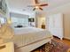 Cozy main bedroom with a ceiling fan, large windows, and a stylish ensuite at 3138 Nautical S Pl, St Petersburg, FL 33712