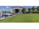 Scenic marina view featuring modern boats, palm trees, and a well-maintained lawn at 3138 Nautical S Pl, St Petersburg, FL 33712