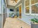 Cozy screened-in patio with tile flooring, ceiling fan, and comfortable seating area at 3138 Nautical S Pl, St Petersburg, FL 33712