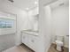 Well-lit bathroom featuring a double vanity and modern fixtures, and separate water closet at 31647 Malbec Dr, Brooksville, FL 34602