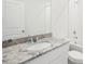 Bright bathroom with granite countertop, white cabinets, and shower-tub combo at 31647 Malbec Dr, Brooksville, FL 34602