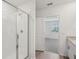 Modern bathroom boasts glass shower, granite vanity, and tile flooring, with view into bedroom at 31647 Malbec Dr, Brooksville, FL 34602