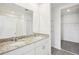 Modern bathroom featuring double sinks with granite countertops, white cabinets, and walk-in shower at 31647 Malbec Dr, Brooksville, FL 34602