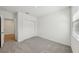 Bedroom features neutral carpet, white walls, and closet with sliding doors at 31647 Malbec Dr, Brooksville, FL 34602