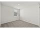 Bright bedroom features neutral carpeting, a single window, and fresh white walls at 31647 Malbec Dr, Brooksville, FL 34602