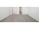 Spacious empty bedroom features neutral carpet, white walls, and doorway leading to an adjoining room at 31647 Malbec Dr, Brooksville, FL 34602