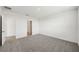 Empty bedroom showcasing neutral carpet and white walls, leading to an ensuite bathroom at 31647 Malbec Dr, Brooksville, FL 34602