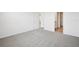 Spacious bedroom with neutral carpeting, a closet, and access to an ensuite bathroom at 31647 Malbec Dr, Brooksville, FL 34602