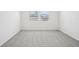 Bright bedroom features neutral carpeting and two windows, providing ample natural light at 31647 Malbec Dr, Brooksville, FL 34602