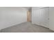 An empty bedroom featuring neutral carpet, white walls and a closet at 31647 Malbec Dr, Brooksville, FL 34602