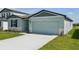 Beautiful single-Gathering home with a two-car garage, lush lawn, and stone veneer accents at 31647 Malbec Dr, Brooksville, FL 34602