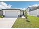 Charming single-story home featuring a two-car garage and landscaped front yard at 31647 Malbec Dr, Brooksville, FL 34602