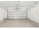 Clean, spacious garage with a white automatic door and concrete floor, ready for parking and storage at 31647 Malbec Dr, Brooksville, FL 34602