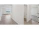 Hallway features tile floors and view into a bedroom and a sunlit living area at 31647 Malbec Dr, Brooksville, FL 34602