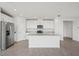 Modern kitchen with stainless steel appliances, granite countertops, and a center island at 31647 Malbec Dr, Brooksville, FL 34602