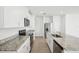 Modern kitchen with stainless steel appliances, granite countertops, and white cabinets at 31647 Malbec Dr, Brooksville, FL 34602