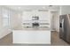 Kitchen with stainless steel refrigerator, granite countertop, and eat-in island at 31647 Malbec Dr, Brooksville, FL 34602