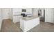 Stylish kitchen boasts granite island, modern appliances, and ample cabinet space at 31647 Malbec Dr, Brooksville, FL 34602