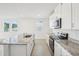 Bright kitchen features granite countertops, stainless appliances, and natural light at 31647 Malbec Dr, Brooksville, FL 34602