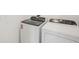 White laundry room featuring a Whirlpool washer and dryer, with digital displays and user-friendly controls at 31647 Malbec Dr, Brooksville, FL 34602