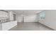 Open-concept living room area with light-filled modern kitchen with granite countertops at 31647 Malbec Dr, Brooksville, FL 34602