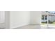 Bright, open living room with white walls, tile flooring, and natural light at 31647 Malbec Dr, Brooksville, FL 34602