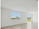 Bright living room with wood-look tile floors and sliding glass door access to outdoor at 31647 Malbec Dr, Brooksville, FL 34602